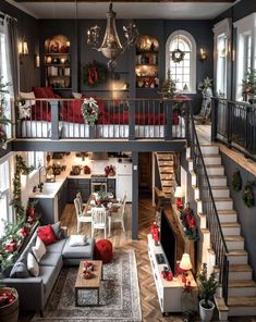 a living room filled with lots of furniture and christmas decorations on top of the stairs