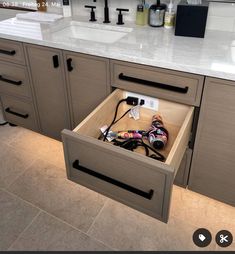 an open drawer in the middle of a kitchen counter