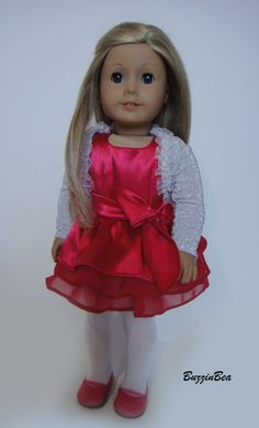 a doll with blonde hair wearing a red dress and pink shoes is standing in front of a white background