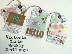 three tags with the words victoria marie weekly challenge written on them, hanging from twine strings