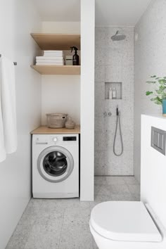 a washer and dryer in a small bathroom with white tile flooring, open shelving