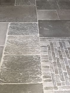 the floor is made out of different types of stone and has been laid in rows