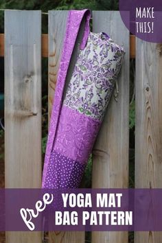 a yoga mat bag hanging on a wooden fence