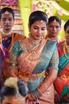 a woman in a sari standing next to other people