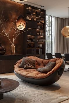 a living room filled with lots of furniture next to a tall wall mounted book shelf