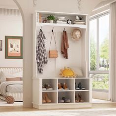 a white shelf filled with shoes next to a bed