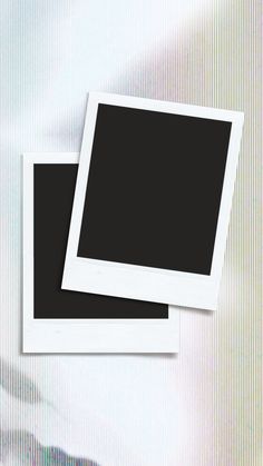 two white polaroid frames sitting side by side on top of a striped wallpaper