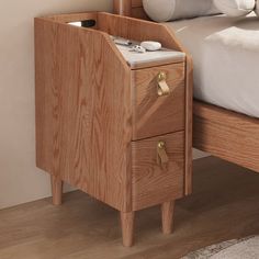 a bed with a wooden headboard and night stand next to a white rug on the floor