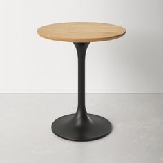 a round wooden table sitting on top of a white floor