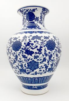 a blue and white vase sitting on top of a table