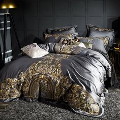 a bed covered in black and gold comforter with hot sale sticker on it