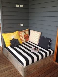 a black and white striped couch sitting on top of a wooden floor next to a door