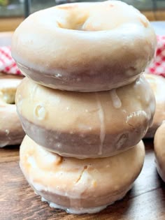 a stack of doughnuts sitting on top of a wooden table