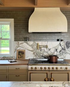 a stove top oven sitting inside of a kitchen