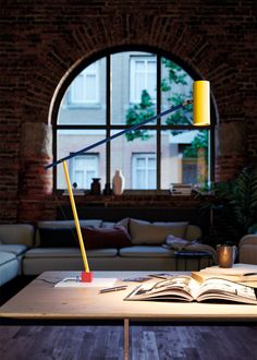 The Ettorino Table Lamp offers an updated take on the classic design of articulated desk lamps. Ettorino features an adjustable arm that can be raised and lowered and a swiveling cylindrical head to aim light precisely where it is needed for reading and other tasks. The lamp's form is composed of simple geometric shapes for a versatile look with a modern expression. A small detail of a dancing figure at the end of the arm completes the look with a charming accent. Dimmer switch located on cord. Indoor Lamps, Dancing Figures, Three Primary Colors, Primary Colours, Indoor Lamp, Estilo Art Deco, Entry Foyer, Work Surface, Innovative Design