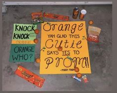 a sign that is on the ground with candy and candies around it saying orange yah glad this cutie says yes to prom