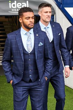 Sport a winning look with the Edinson navy blue three piece suit in sky check, the official West Bromwich Albion F.C. club's suit. As worn by Darnell Furlong, Grady Diangana, Martin Kelly & Okay Yokuşlu. In a rich navy blue with a subtle Prince of Wales check and overlayed with a soft sky blue windowpane check, this suit is made with added elastane, to work with you from desk to dance floor. Features Slim fit Single-breasted Notch lapel Single back vent Four button cuff Double button blazer fast Navy Blue Window Pane Suit, King And Allen Suits, Blue Windowpane Suit Men, Blue Wedding Suit Groom Navy, Blue Plaid Suit For Men, Navy Blue Mens Suits Wedding, Blue Wedding Suit Groom, Navy Blue Suits, Wedding Suits Men Blue