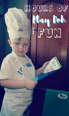 a young boy wearing a chef's hat and holding a piece of paper