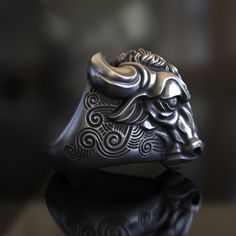 Embrace the power and majesty of nature with our stunning Majestic Bull Head Ring. Crafted from premium 925 sterling silver, this unisex statement piece is a testament to fine artisanship and bold design. Each ring is meticulously handcrafted, ensuring a unique and personal touch that mass-produced jewelry simply can't match. The intricately detailed bull's head captures the essence of strength, determination, and earthly connection. From the powerful horns to the expressive eyes, every aspect o Bull Ring, Handcrafted Silver Jewelry, Bull Head, Viking Ring, Masonic Ring, Head Ring, Retro Ring, Animal Rings, Handmade Rings