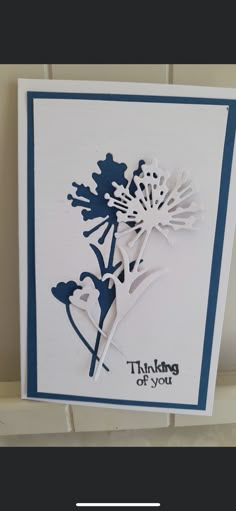 a card with the words thinking about you and a dandelion design on it