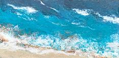 an aerial view of the ocean with waves coming in from the shore and blue water