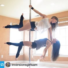 two women are doing pole dancing in a room with no one on the phone or another person