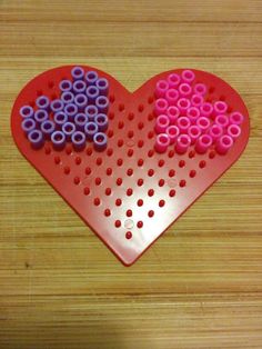 a heart shaped peg board with two hearts on it