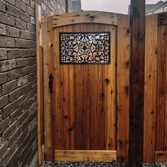 a wooden gate with an intricate iron window