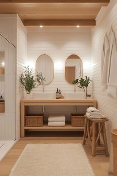 a bathroom with two sinks and mirrors on the wall