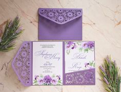 purple and white wedding stationery with flowers on the front, envelope and back side