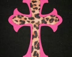 a pink and black cross with leopard print on it