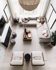 an overhead view of a living room with white furniture