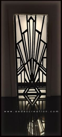 an art deco door is shown in this black and white photo with the light shining through it