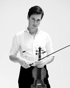 a man in white shirt holding a violin