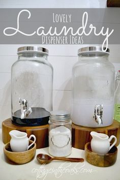 there are two glass jars with lids and spoons next to each other