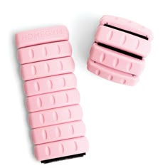 two pink combs sitting next to each other on a white surface with the words home gym written on them