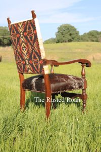 an old wooden chair sitting in the middle of a field