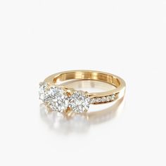 three stone diamond ring in yellow gold with diamonds on the band and side stones at each end