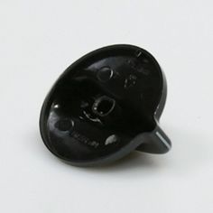 a small black object sitting on top of a white table