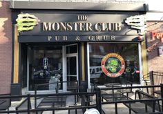 there is a sign that says the monster club pub and grub