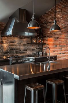 an industrial style kitchen with stainless steel appliances and bar stools in front of the sink