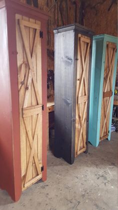 three tall wooden doors sitting next to each other in a room filled with wood flooring