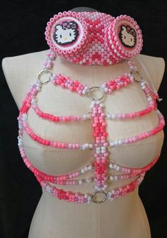 Pink and white beaded kandi chest harness. (masks sold separately) the cheat harness has glow in th3 dark beads and also does shine under uv light as pictured. This harness is handmade by me.  Perfect for accessorizing your festival outfits or any rave outfit, or to add to any awesome Kandi collection!! Check out/follow my socials (@ TicTacToeCreations on FB and IG + linktr.ee/TicTacToeCreations ) for more fun things that haven't been posted on shops yet.  I happily do custom orders of many of the things posted on my socials as well!  💖⭐ Thanks!  🫶PLUR⭐💖 Kandi Collection, Chest Harness, Rave Outfit, Rave Outfits, Uv Light, White Beads, Festival Outfits, Fun Things, Pink And White