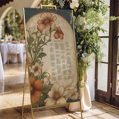 a sign with flowers on it sitting in front of a table