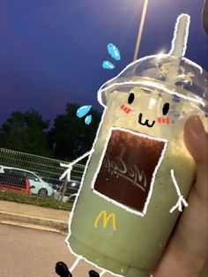 a person holding up a plastic cup with ketchup and mustard on it in front of a parking lot