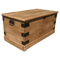 an old wooden trunk with black straps on the top and bottom, sitting against a white background