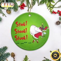 a green christmas ornament with the grin on it's face and words stink, stank, stuk