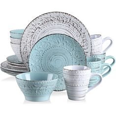 a set of blue and white dinnerware on a white background with an intricate design