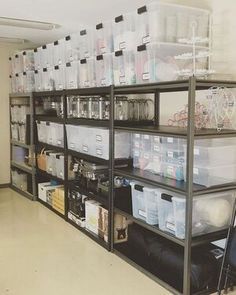 the shelves are filled with plastic containers and other items for storage in an office building