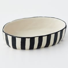 a black and white striped bowl sitting on top of a table